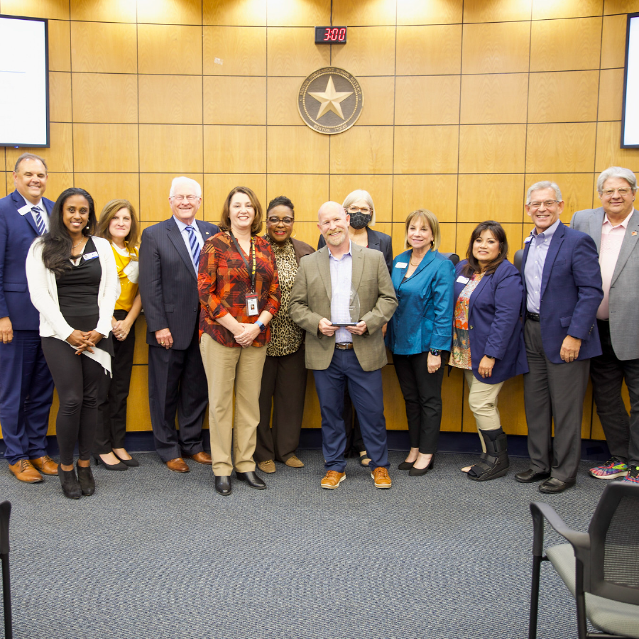 Denton ISD Staff Pose with an award